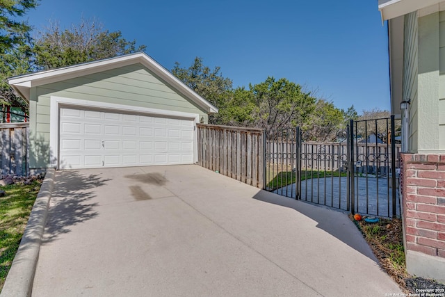 detached garage featuring a gate and fence