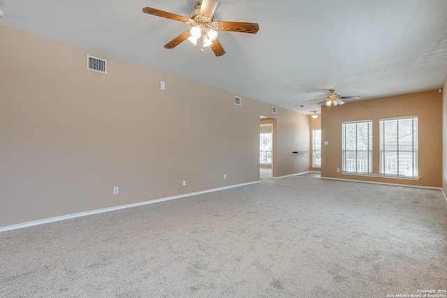 carpeted spare room with visible vents, plenty of natural light, and baseboards