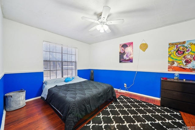 bedroom featuring ceiling fan, wood finished floors, and baseboards