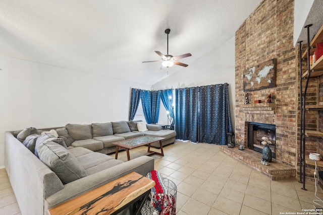 living area with a brick fireplace, light tile patterned flooring, vaulted ceiling, ceiling fan, and a textured ceiling