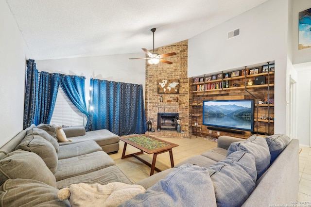 tiled living room featuring a textured ceiling, ceiling fan, high vaulted ceiling, a fireplace, and visible vents