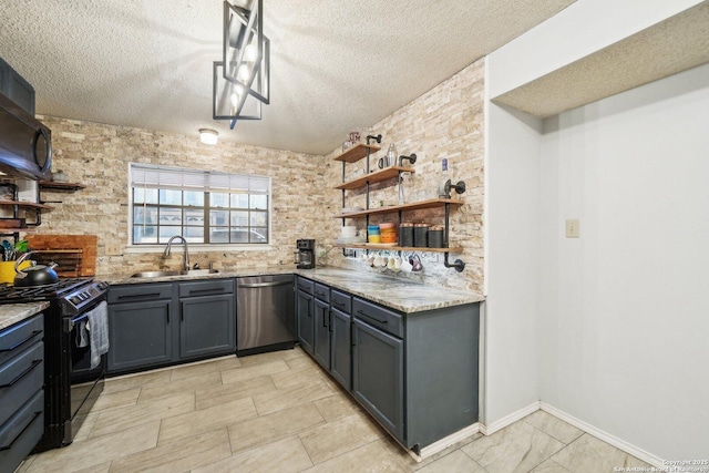 kitchen with light stone counters, a textured ceiling, black appliances, open shelves, and a sink