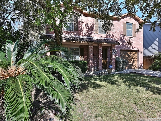 view of front of property featuring driveway, an attached garage, fence, a front lawn, and brick siding