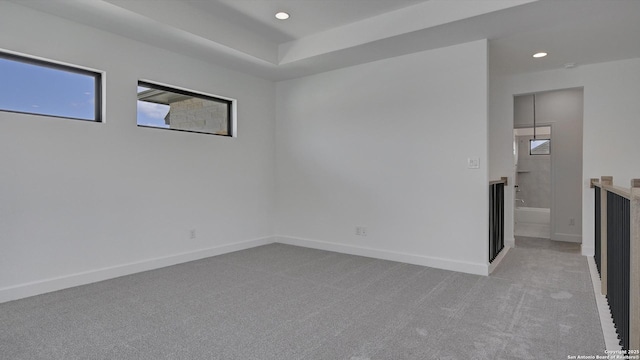 spare room featuring light carpet, baseboards, and recessed lighting