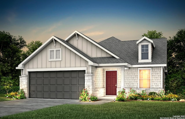 view of front of house featuring a yard, an attached garage, board and batten siding, stone siding, and driveway