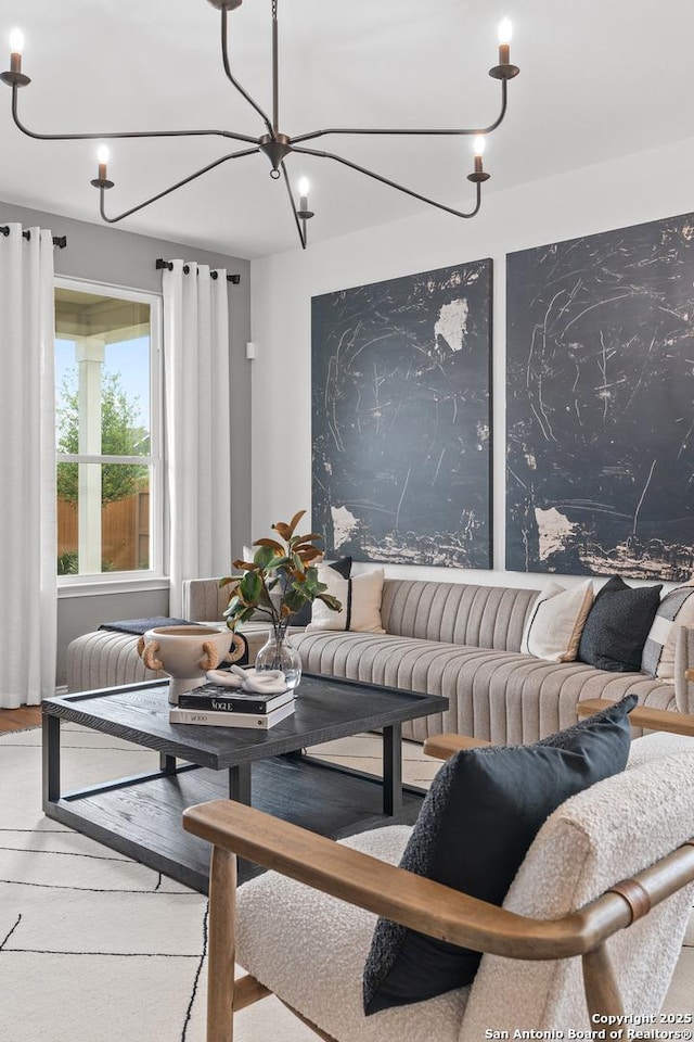 living area featuring a chandelier and wood finished floors