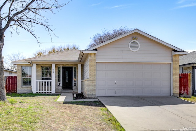 single story home featuring driveway, brick siding, an attached garage, and fence