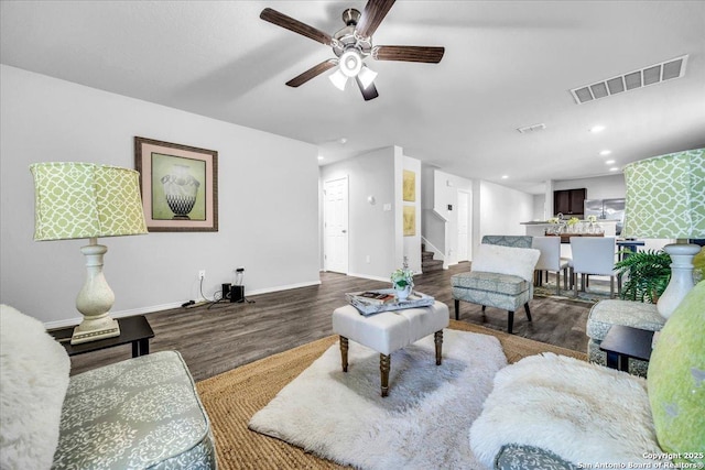 living area with baseboards, visible vents, stairway, wood finished floors, and recessed lighting