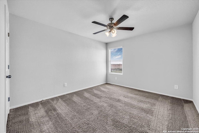 spare room with carpet, ceiling fan, and baseboards