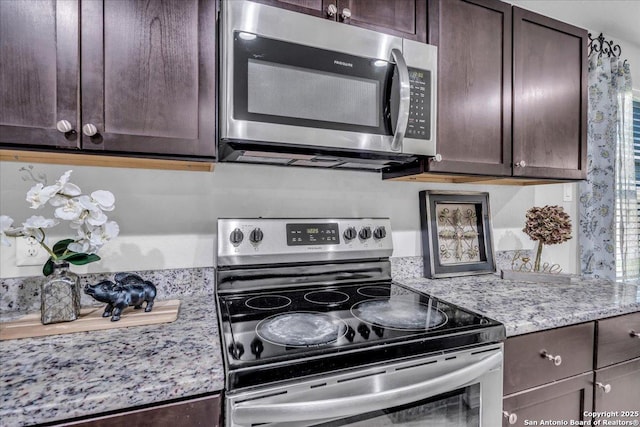 kitchen with appliances with stainless steel finishes and dark brown cabinets