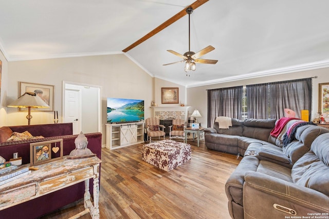 living area featuring a fireplace, crown molding, lofted ceiling, ceiling fan, and wood finished floors