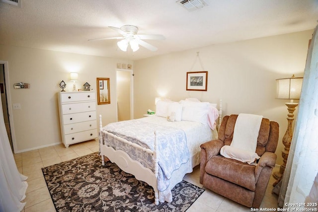 bedroom featuring ceiling fan, light tile patterned flooring, and visible vents