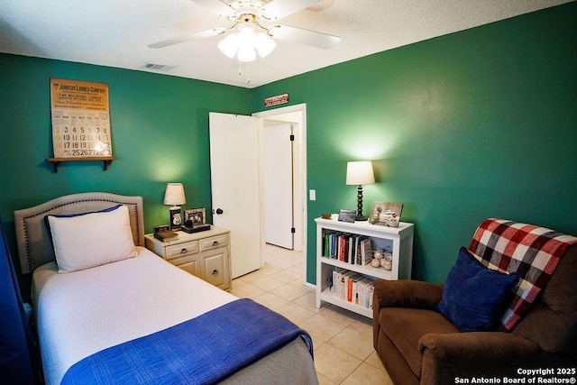 bedroom featuring light tile patterned floors, visible vents, and a ceiling fan