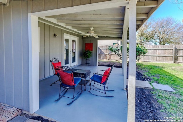 view of patio with fence, a ceiling fan, and french doors