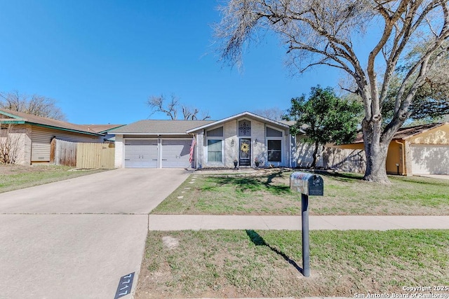 mid-century home with a garage, a front yard, concrete driveway, and fence