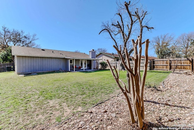 view of yard featuring a patio area and a fenced backyard