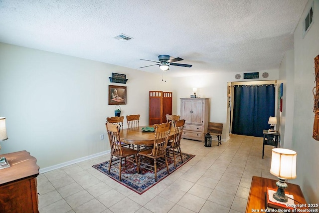 dining room with visible vents, a textured ceiling, and light tile patterned floors