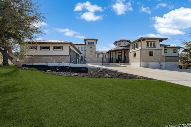 rear view of house featuring a yard, stucco siding, a standing seam roof, metal roof, and stone siding