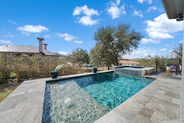 view of swimming pool with a pool with connected hot tub and a patio area