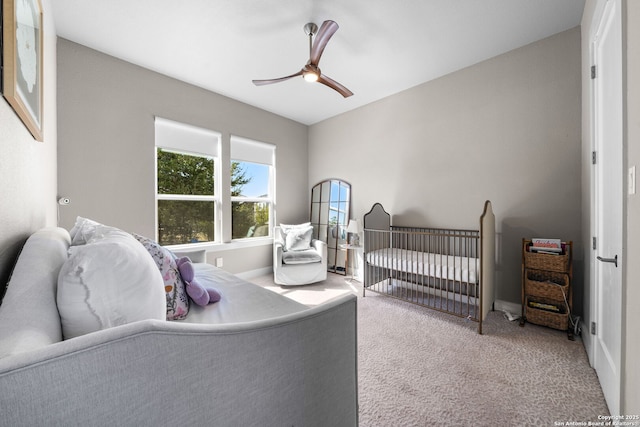 carpeted bedroom featuring a ceiling fan and baseboards