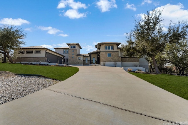 prairie-style house with driveway, a front lawn, stone siding, and stucco siding