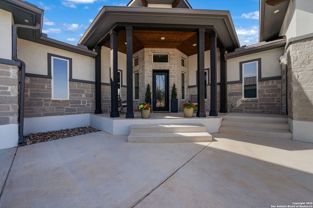 doorway to property with stone siding and stucco siding