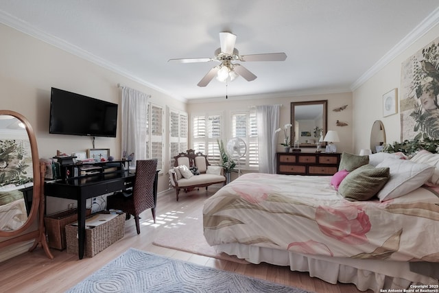 bedroom featuring light wood finished floors, ornamental molding, and a ceiling fan