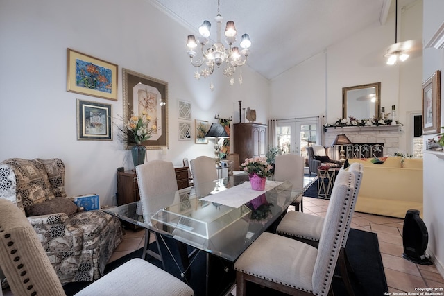 dining area featuring french doors, an inviting chandelier, light tile patterned flooring, a stone fireplace, and high vaulted ceiling