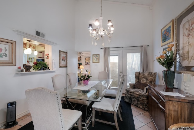 dining space with french doors, visible vents, a high ceiling, and light tile patterned floors