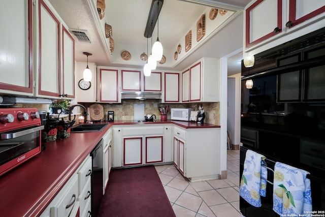 kitchen featuring dark countertops, visible vents, white microwave, light tile patterned flooring, and dishwasher