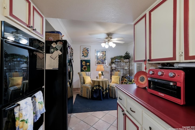 kitchen with ornamental molding, light tile patterned flooring, black appliances, and a ceiling fan