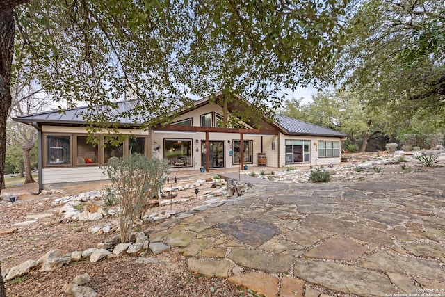 view of front of house featuring a standing seam roof and metal roof