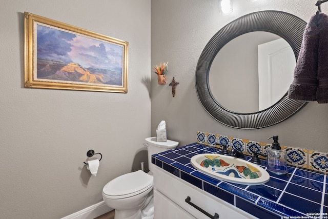 bathroom with toilet and vanity