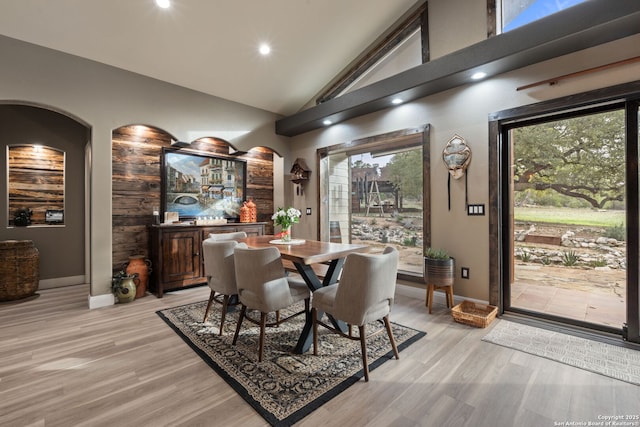 dining space with baseboards, high vaulted ceiling, recessed lighting, and light wood-style floors