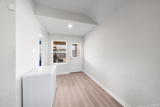 unfurnished room featuring baseboards and light wood finished floors