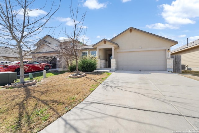 ranch-style house with concrete driveway, an attached garage, and stucco siding