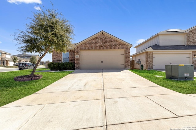 view of front of home with a garage, a front lawn, concrete driveway, and brick siding