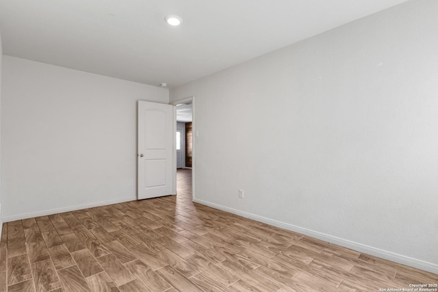 spare room featuring baseboards, recessed lighting, and light wood-style floors