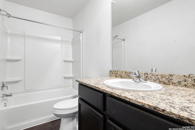 full bathroom with toilet, tub / shower combination, wood finished floors, and vanity