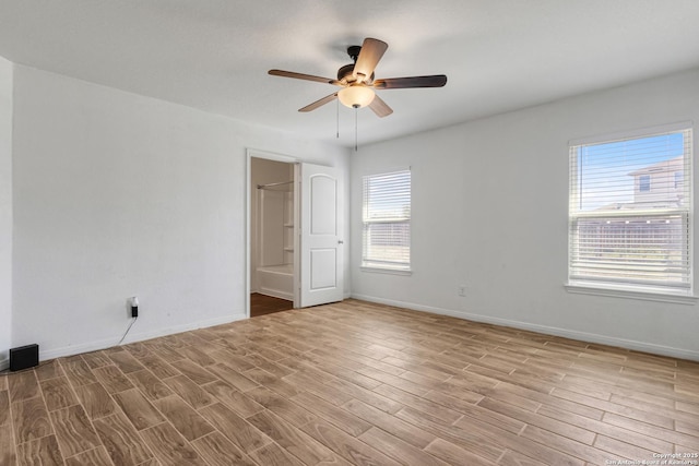 unfurnished room featuring ceiling fan, baseboards, and wood finished floors