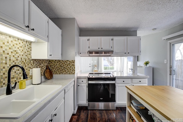 kitchen featuring under cabinet range hood, range with electric cooktop, a sink, white cabinetry, and light countertops