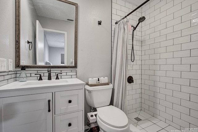 full bathroom with toilet, tasteful backsplash, tiled shower, and vanity