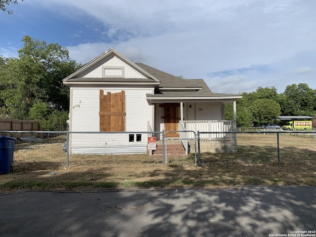 view of front of house with a porch, a fenced front yard, and a gate