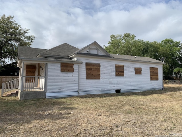 view of side of property with a lawn