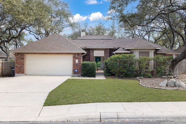 single story home with brick siding, a chimney, concrete driveway, an attached garage, and a front lawn