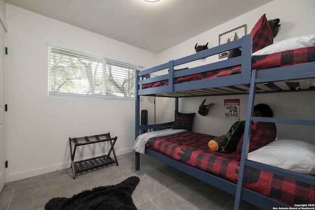 bedroom featuring tile patterned flooring and baseboards