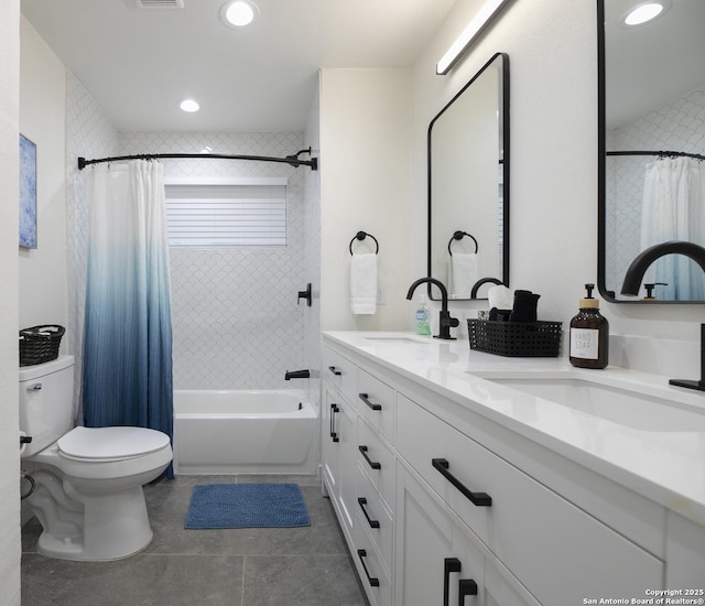 full bath featuring toilet, shower / bathtub combination with curtain, a sink, and tile patterned floors