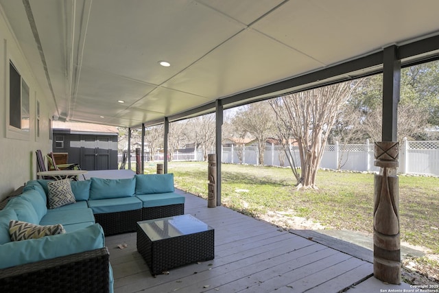 wooden terrace featuring a lawn, outdoor lounge area, and a fenced backyard