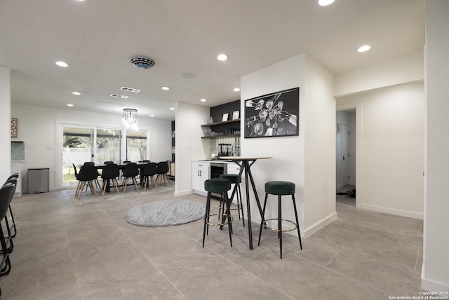 kitchen with visible vents, baseboards, white cabinetry, open shelves, and recessed lighting