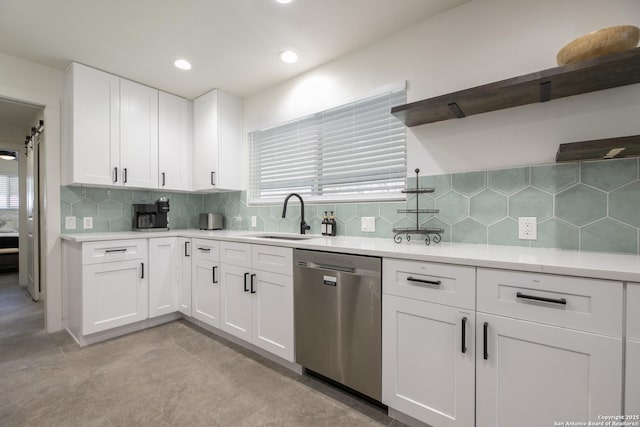 kitchen featuring dishwasher, light countertops, white cabinetry, open shelves, and a sink